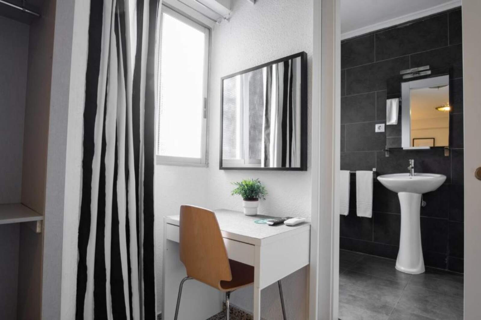 Guest room desk and private bathroom in Valencia